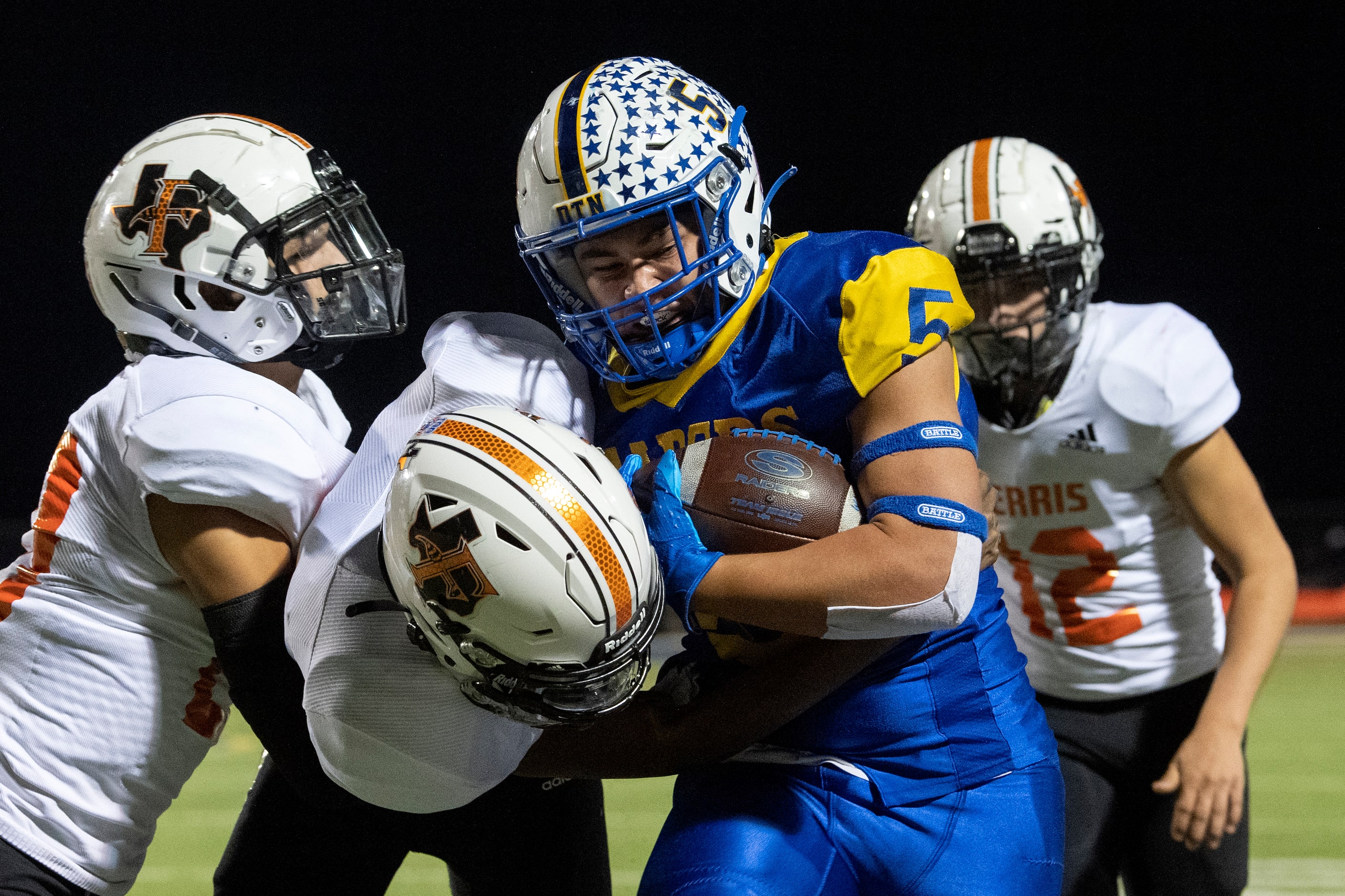 Sunnyvale senior running back Alex Luna (5) is hit by Ferris junior defensive back Devin...