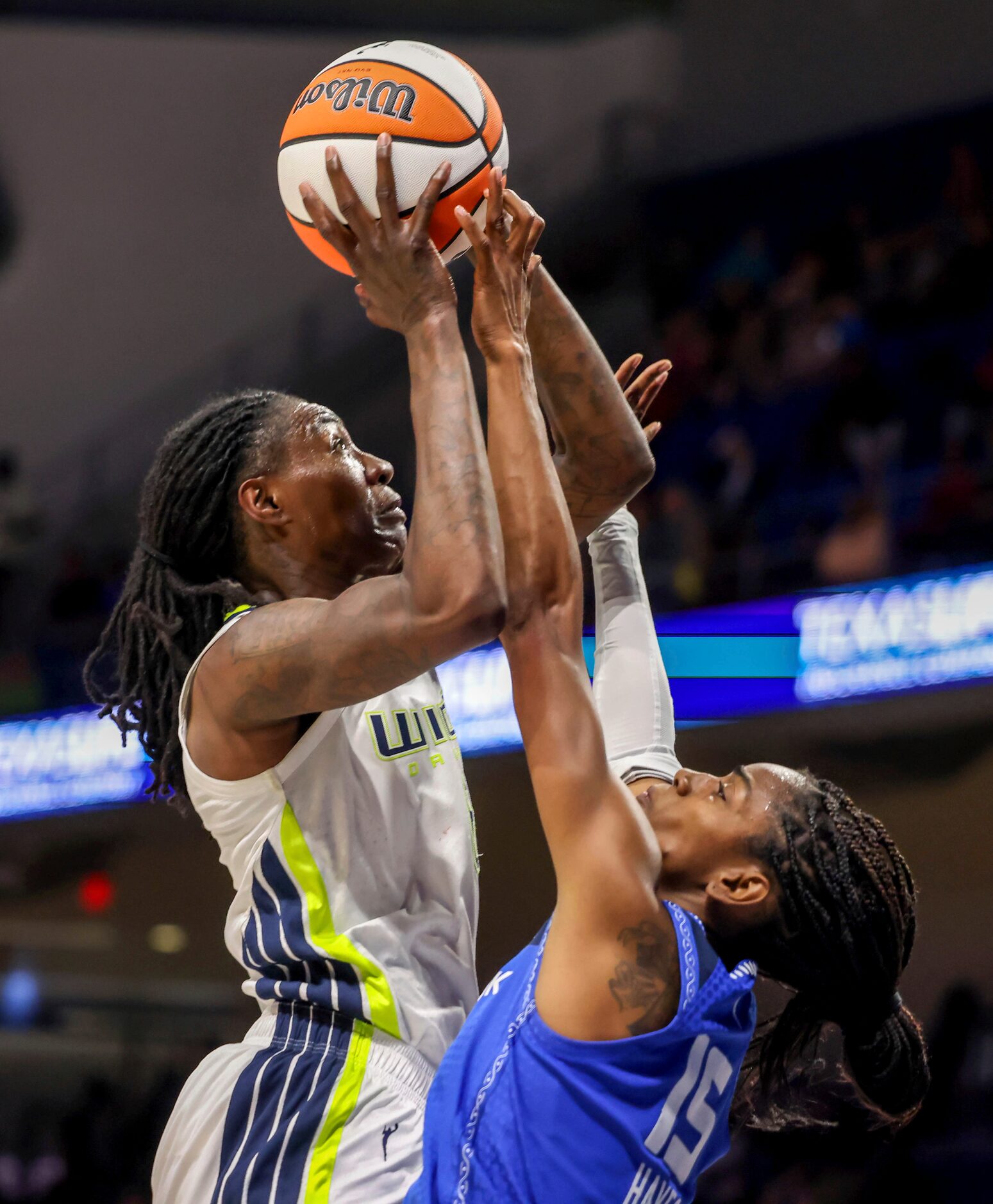 Dallas Wings forward Natasha Howard (6) shoots as Connecticut Sun guard Tiffany Hayes (15)...