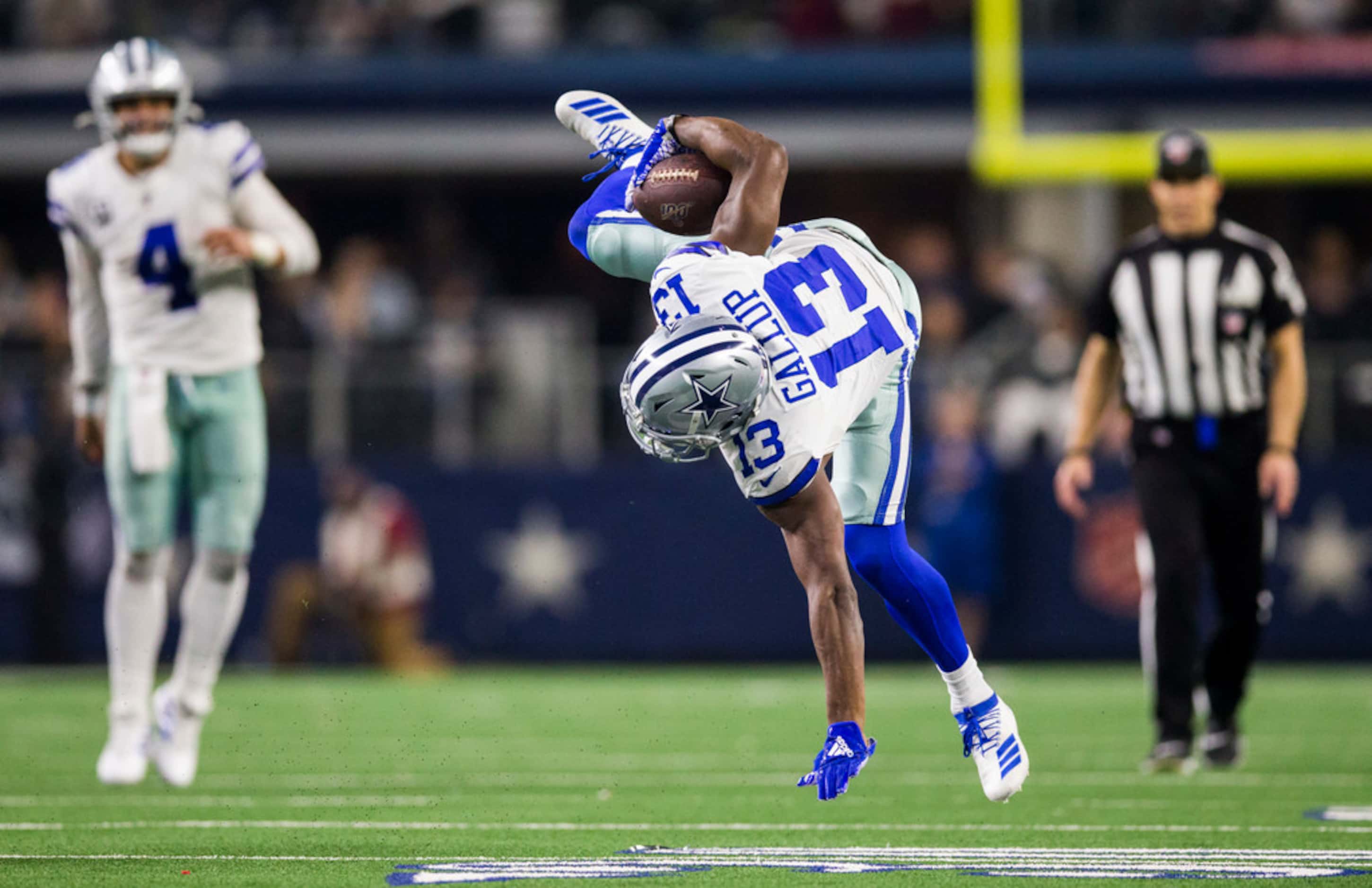 Dallas Cowboys wide receiver Michael Gallup (13) is flipped during a tackle during the third...