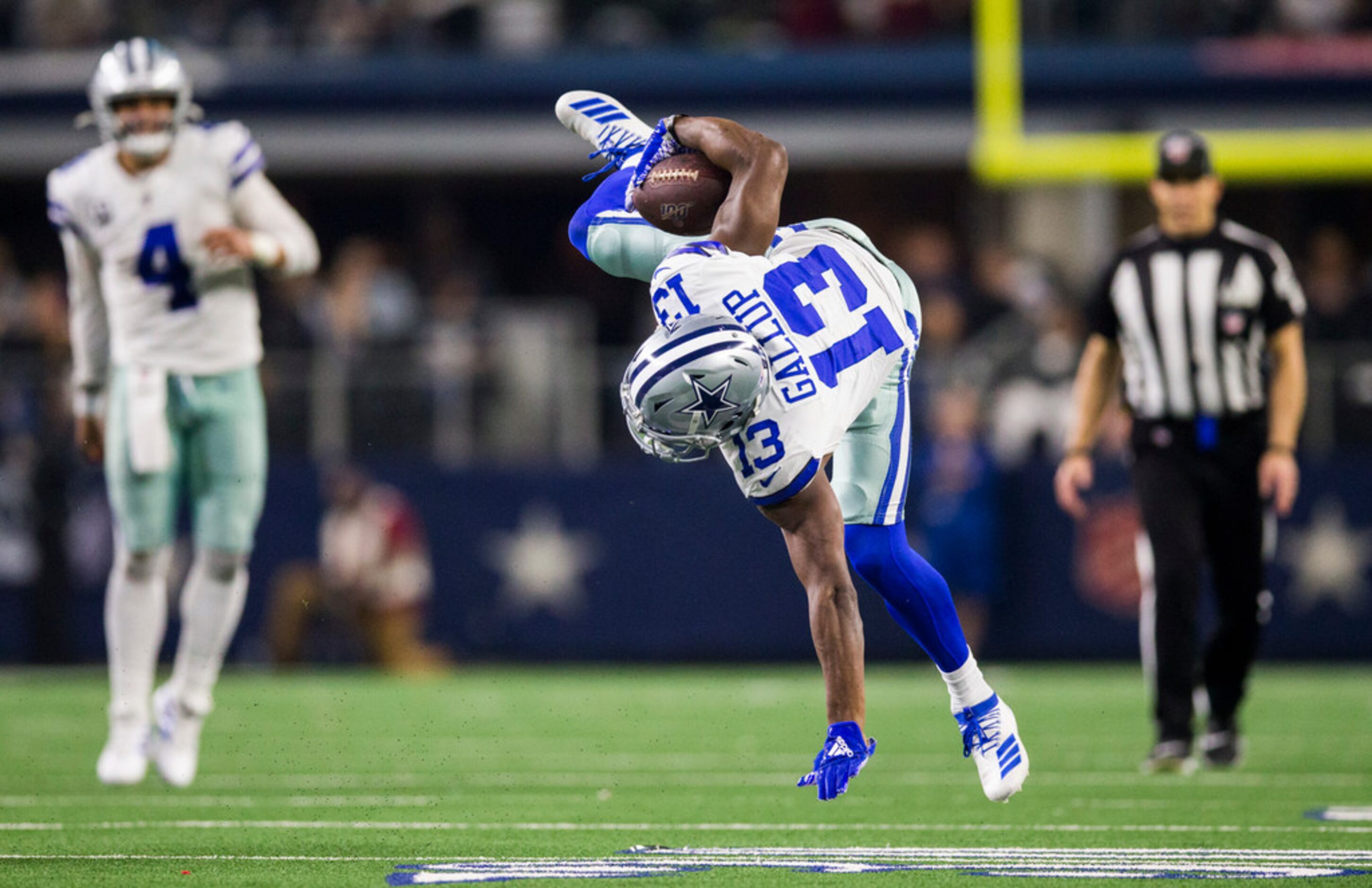 Dallas Cowboys wide receiver Michael Gallup (13) is flipped during a tackle during the third...