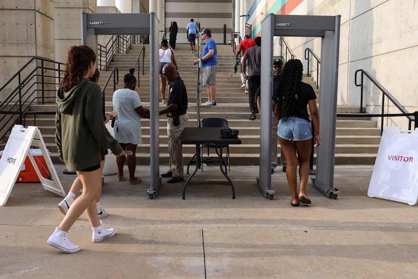 People walk through metal detectors to enter to Standridge Stadium, Friday, August 19, 2022...