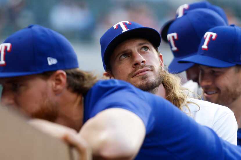 Texas Rangers left fielder Travis Jankowski sits in the dugout before a baseball game...