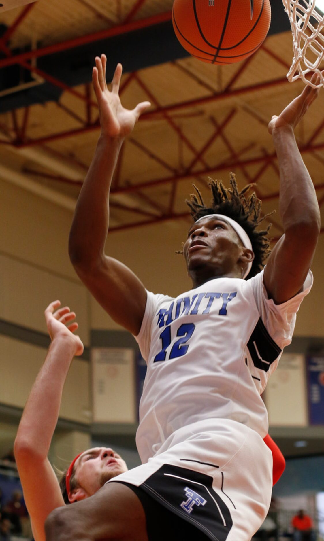 Trinity Christian forward Tyreek Smith (12) skies to pull down a defensive rebound over...