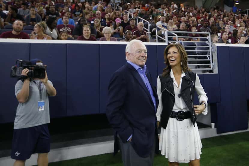 Dallas Cowboys owner and general manager Jerry Jones watches the game alongside his daughter...