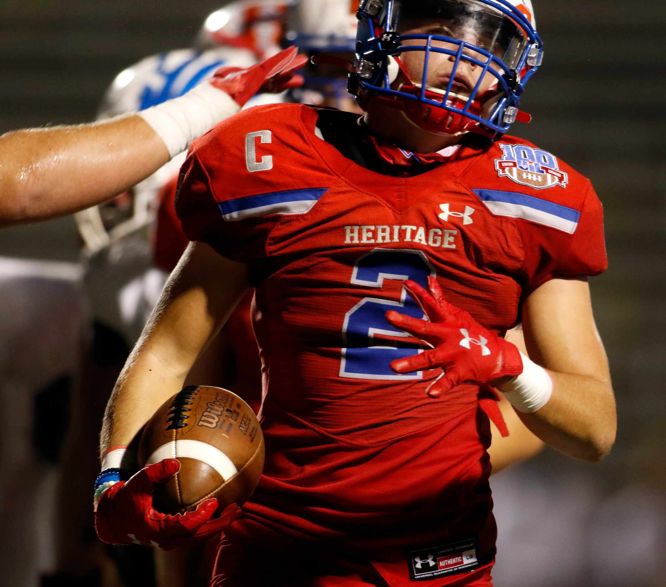 Midlothian Heritage running back Cullen Stone (2) receives a pat on the back from a teammate...