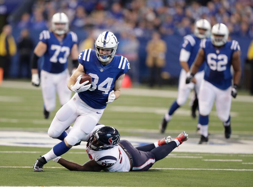 FILE - Indianapolis Colts' Jack Doyle (84) is tackled by Houston Texans' Brandon Dunn (92)...