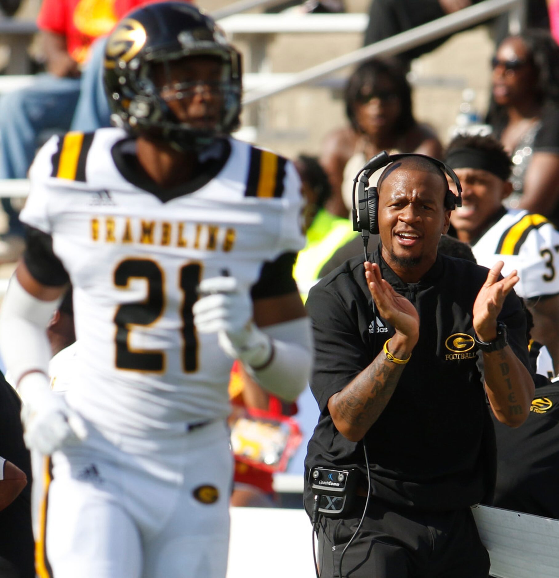 Gambling State assistant coach Quentin Burrell applauds the outcome of a first quarter play...