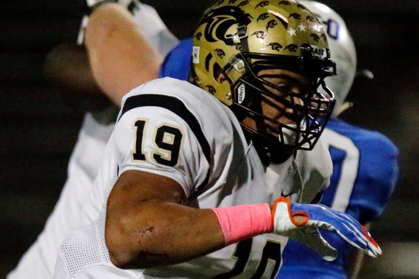 Plano East High School middle linebacker Anthony Hines III (19), an area standout, rushes...