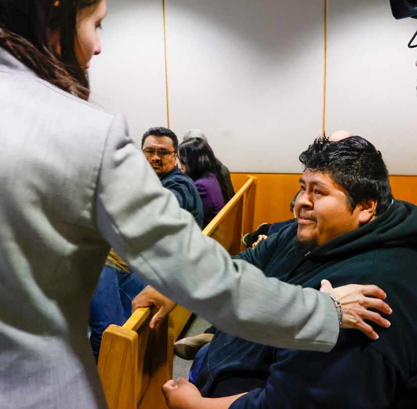 Prosecutor Jessica Trevizo places her hand on the shoulder of Armando Macedonio, the uncle...