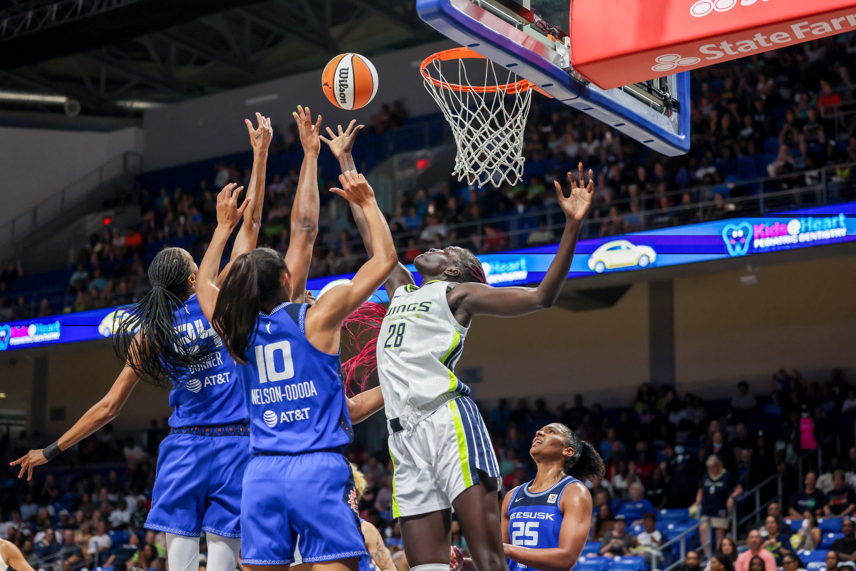 Dallas Wings center Awak Kuier (28) jumps to block an attempted shot by Connecticut Sun at...