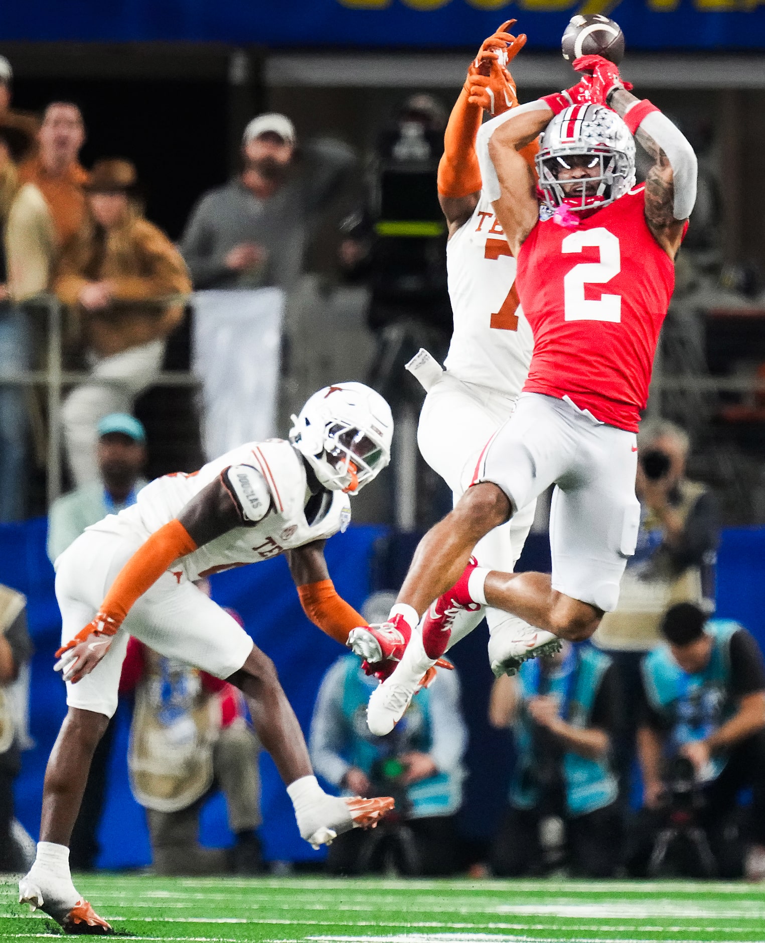 Texas defensive back Jahdae Barron (7) breaks up a pass intended for Ohio State wide...