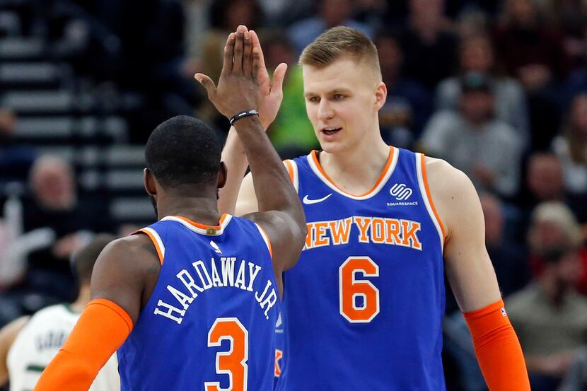 New York Knicks' Tim Hardaway Jr. (3) receives a high-five from Kristaps Porzingis (6) after...
