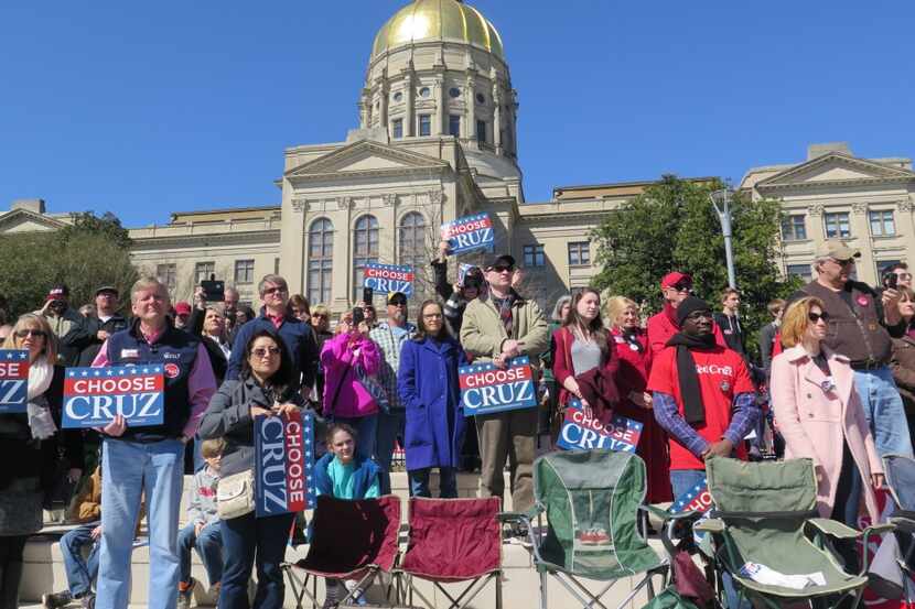  Georgians listen to Sen. Ted Cruz at a campaign stop in the shadow of the Georgia capitol...