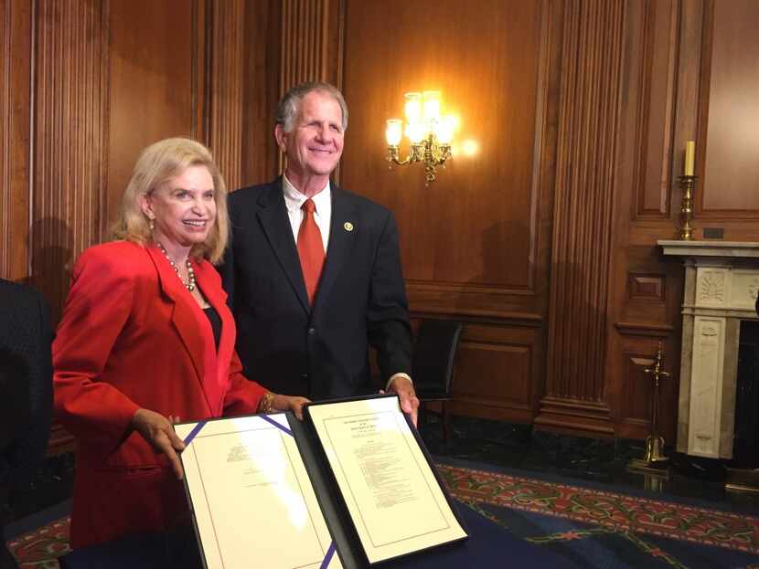  Reps. Carolyn Maloney, D-N.Y., and Ted Poe, R-Humble, pose with the bill signed by Boehner....
