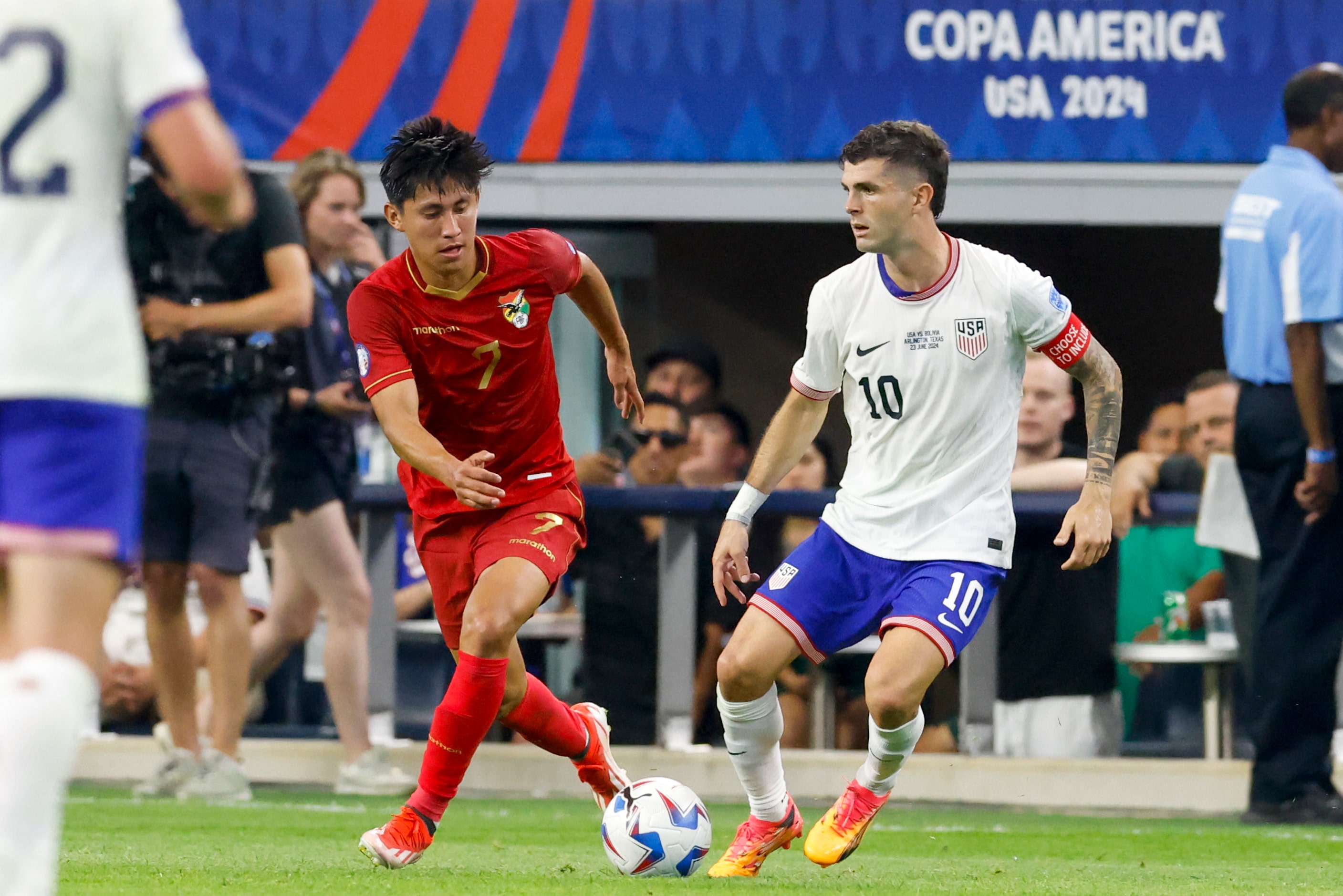 United States forward Christian Pulisic (10) handles the ball alongside Bolivia midfielder...