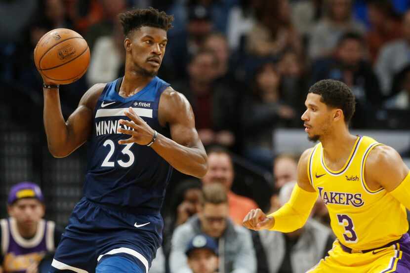 Minnesota Timberwolves' Jimmy Butler, left, looks to pass as Los Angeles Lakers' Josh Hart...