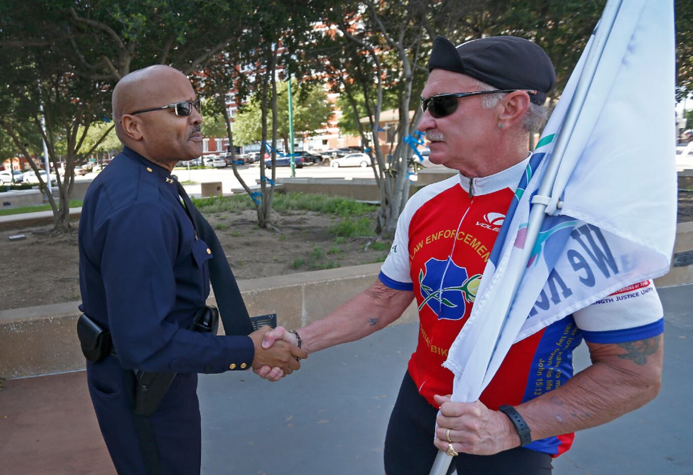 Assistant Chief John Lawton (left) shakes hands with William Harold Hixon, a retired San...