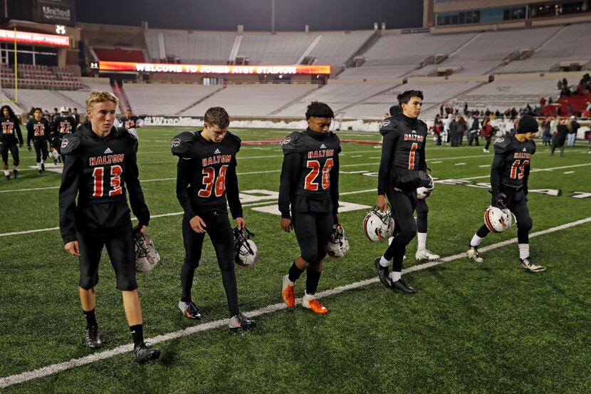 Haltom players walk off the field after the regional final game against Tascosa, Saturday,...