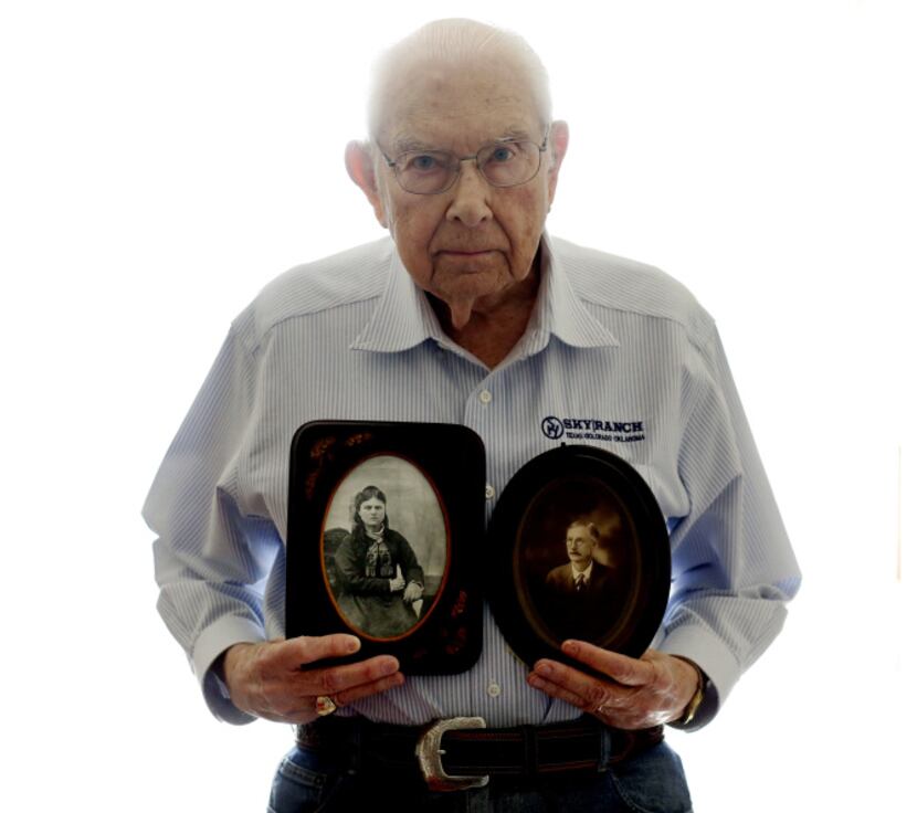 Mel Brewer holds photos of his grandmother, Emma Davis, and grandfather, John Cicero Brewer,...
