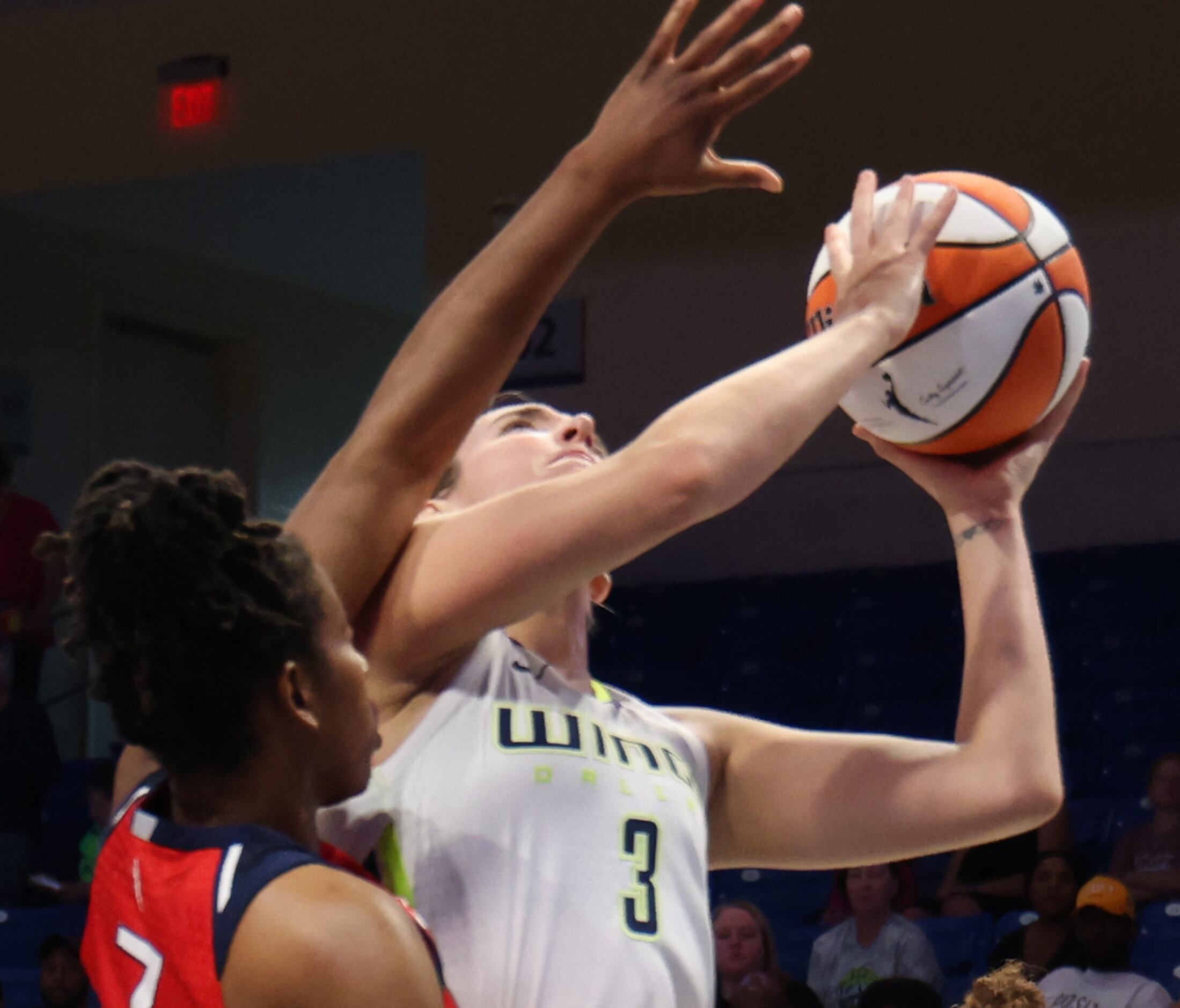 Dallas Wings guard Marina Mabrey (3) drives the lane against the defense of Washington...