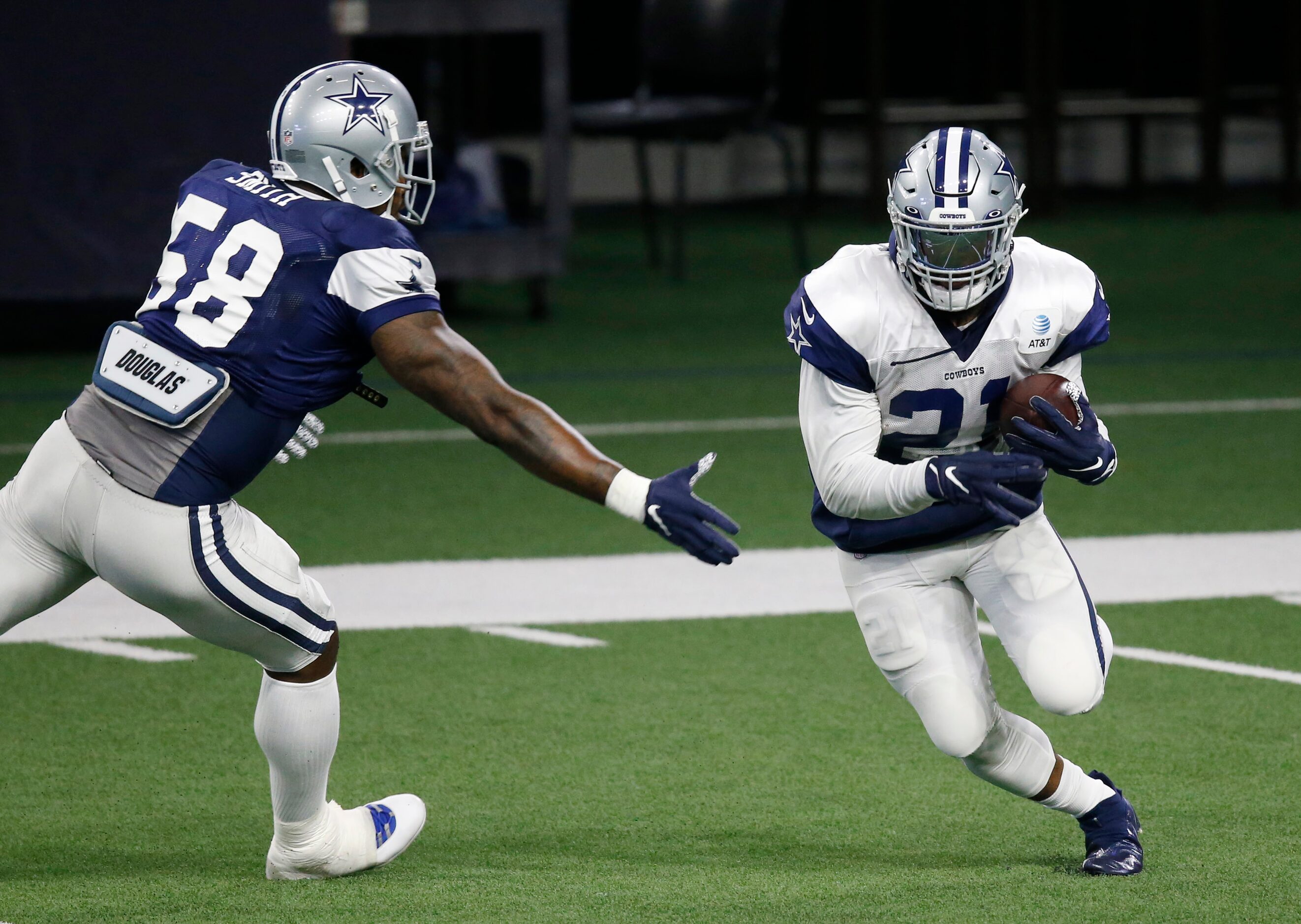 Dallas Cowboys running back Ezekiel Elliott (21) breaks away from Dallas Cowboys defensive...