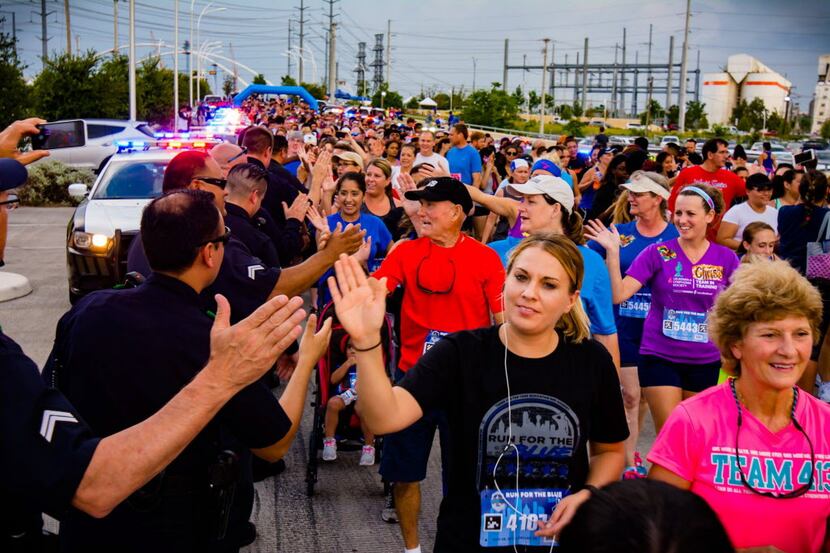 Police officers greet participants at the Run for the Blue race. (2016) ORG XMIT:...