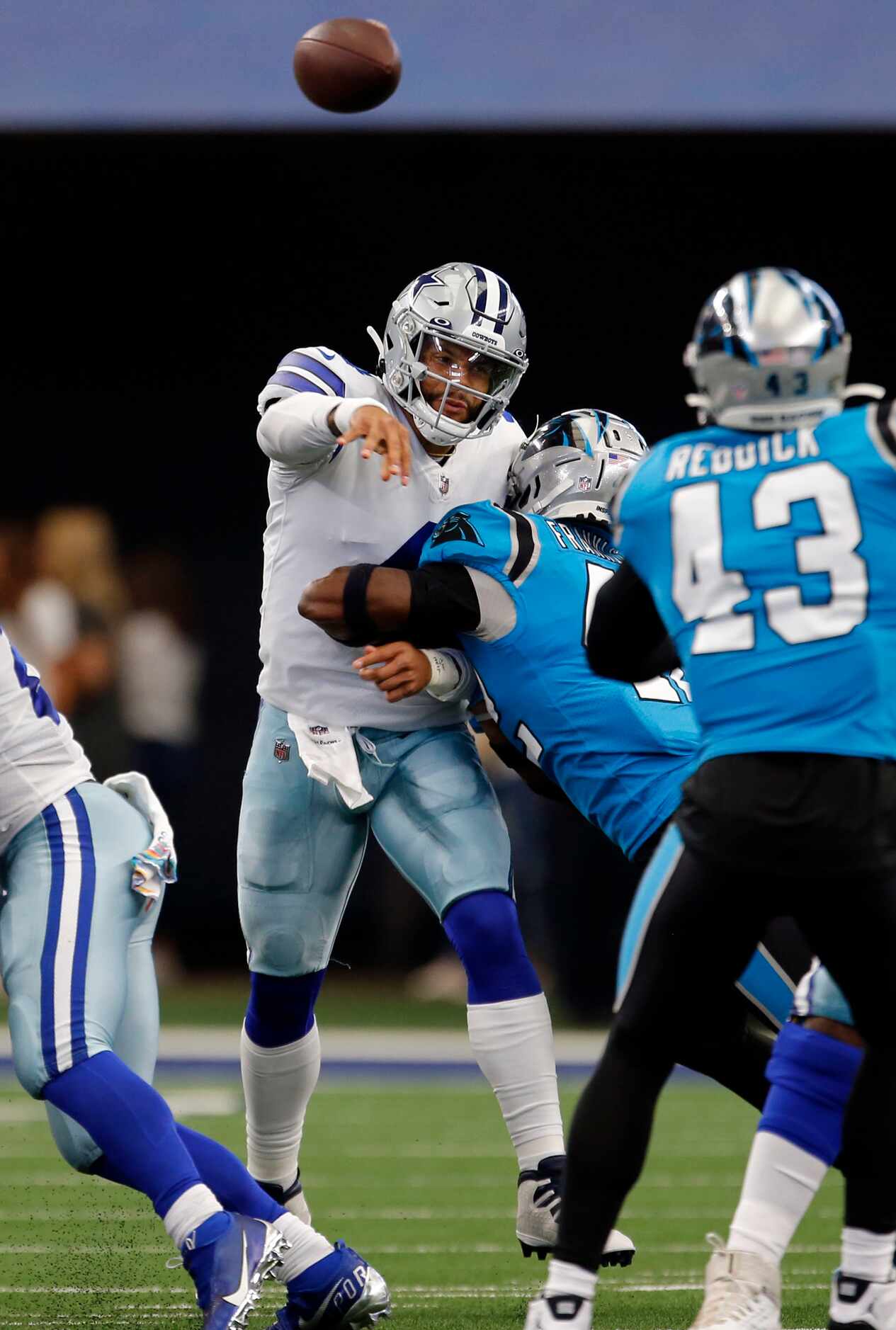 Dallas Cowboys quarterback Dak Prescott (4) is hit by Carolina Panthers safety Sam Franklin...