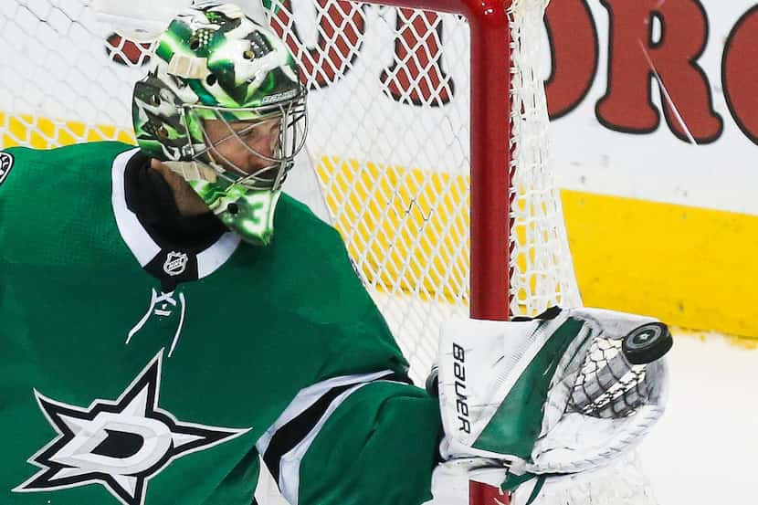 Dallas Stars goaltender Ben Bishop (30) blocks a Minnesota Wild shot on goal during the...