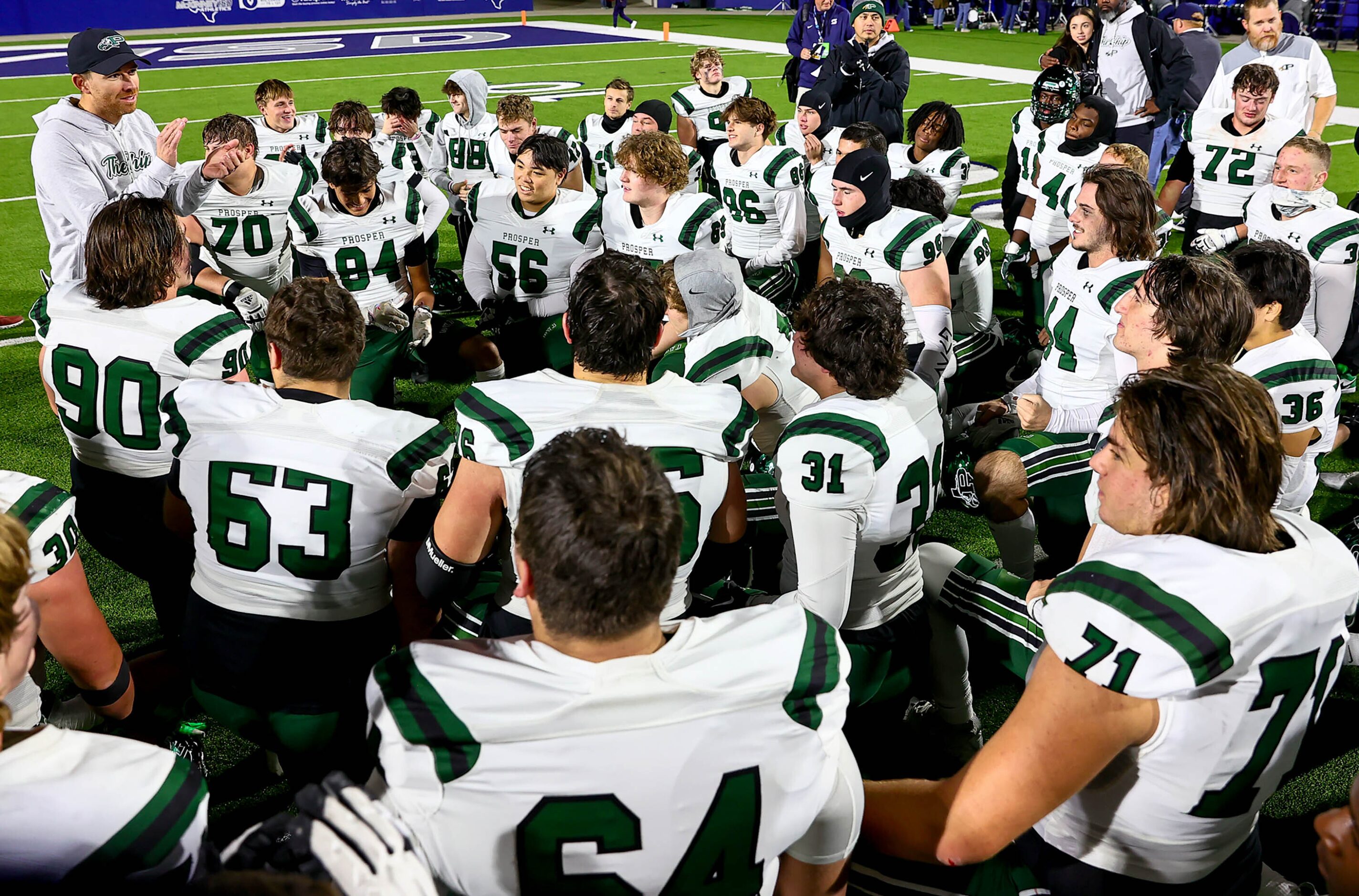 Prosper head coach Tyler Moore (left) talks with his team after their victory over McKinney,...