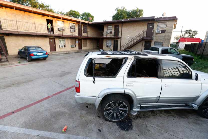 A burned-out Toyota 4Runner sat in the parking lot at 3006 Holmes St. days after someone set...