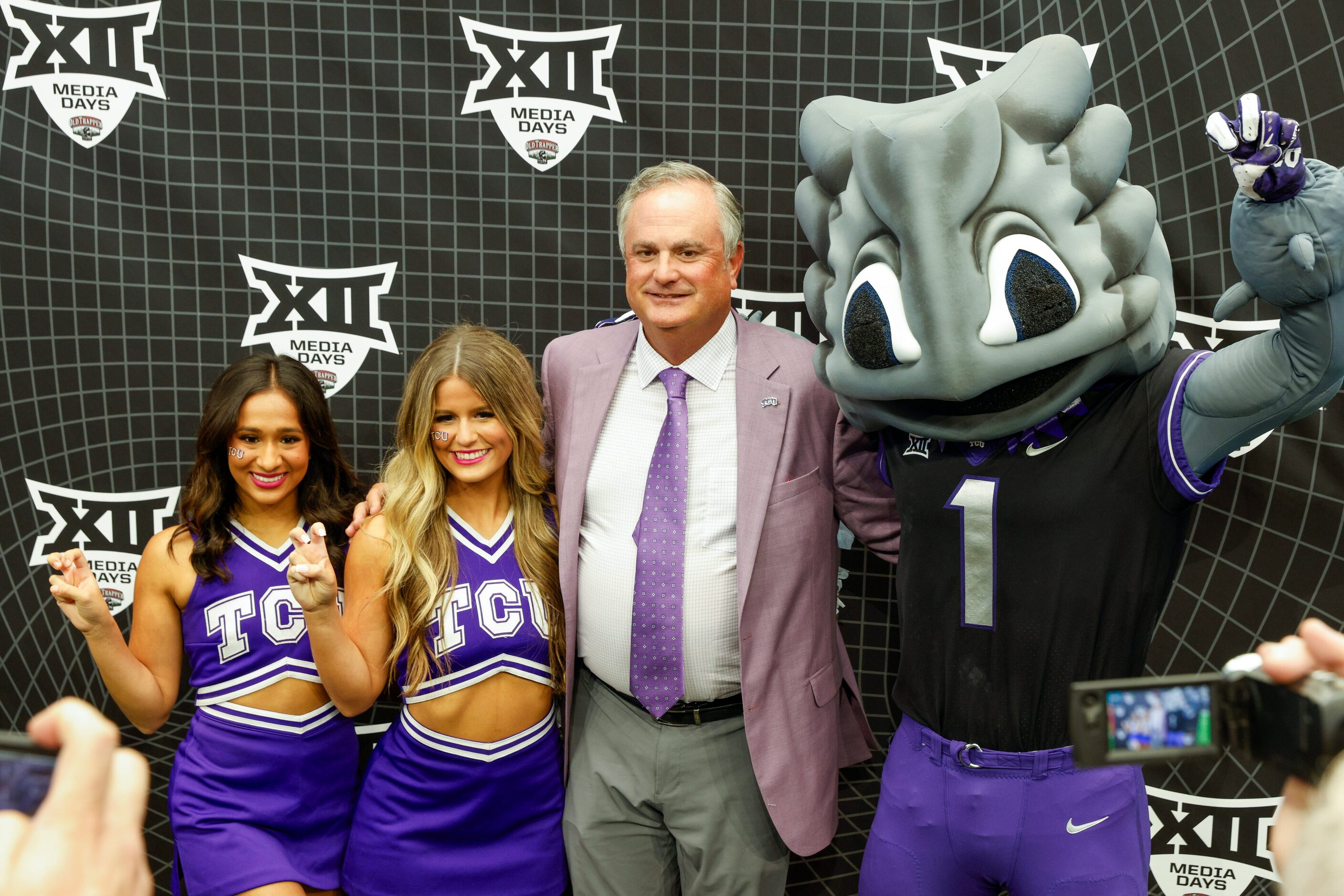 TCU head coach Sonny Dykes poses for a photo with TCU cheerleaders and mascot SuperFrog...