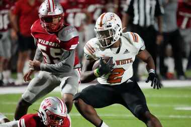 W.T. White Daviawn Bishop (2) looks for room against the Woodrow Wilson defense during the...