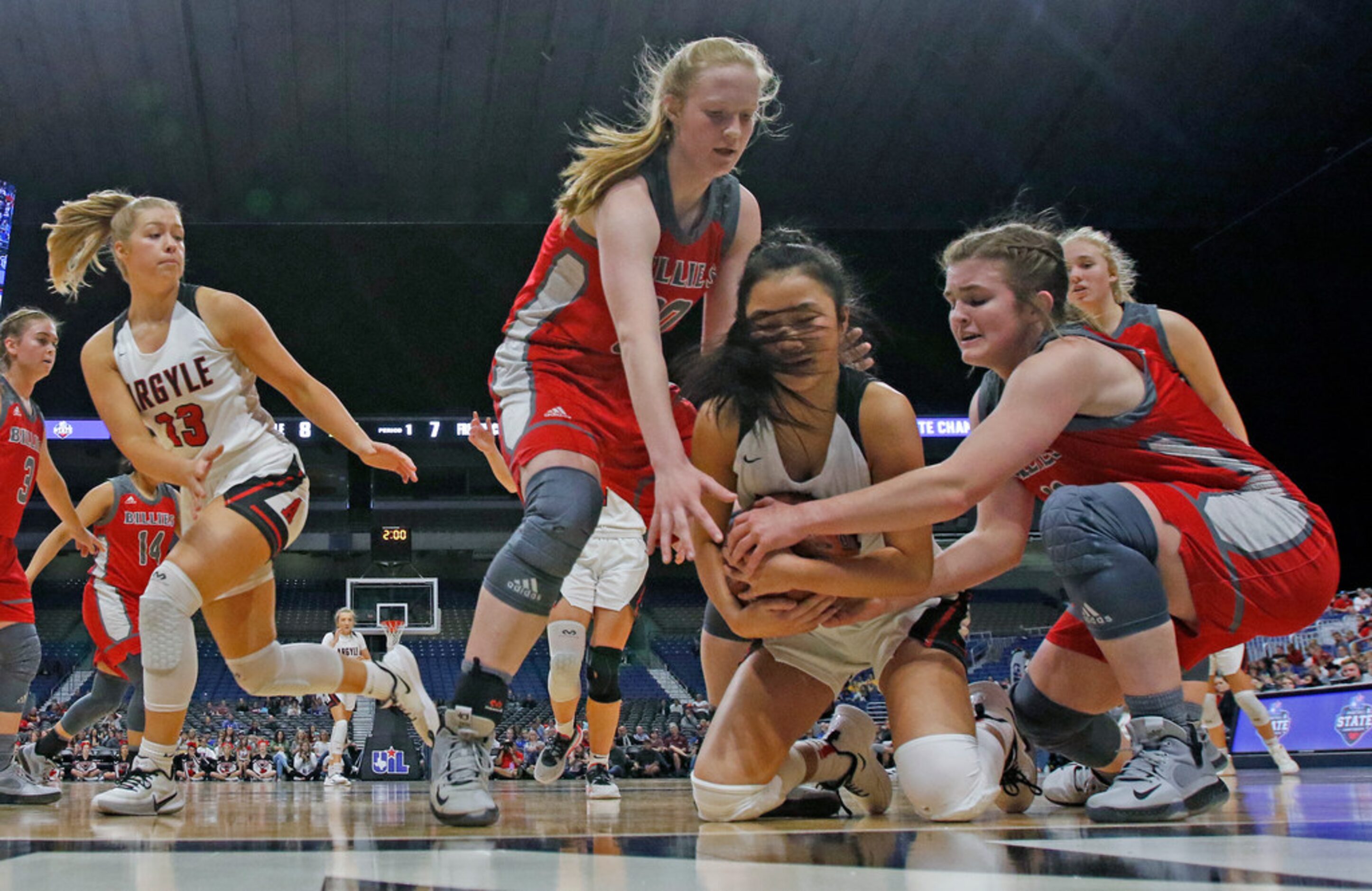 Argyle guard Madi Lumsden #32  is tied but by Fredericksburg center Audrey Spurgin #30 and...