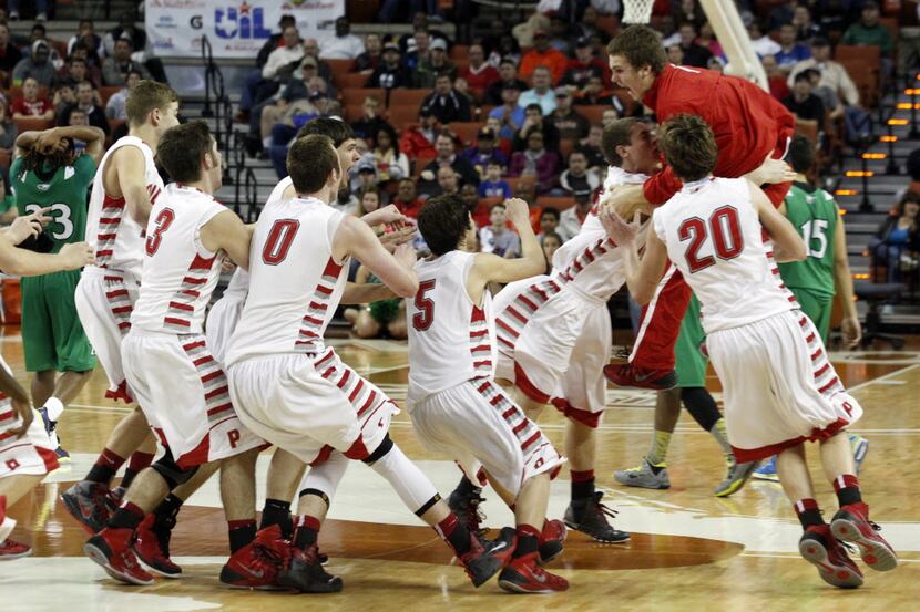 Ponder player celebrate after they defeated Tatum to win their boys basketball Class 2A boys...