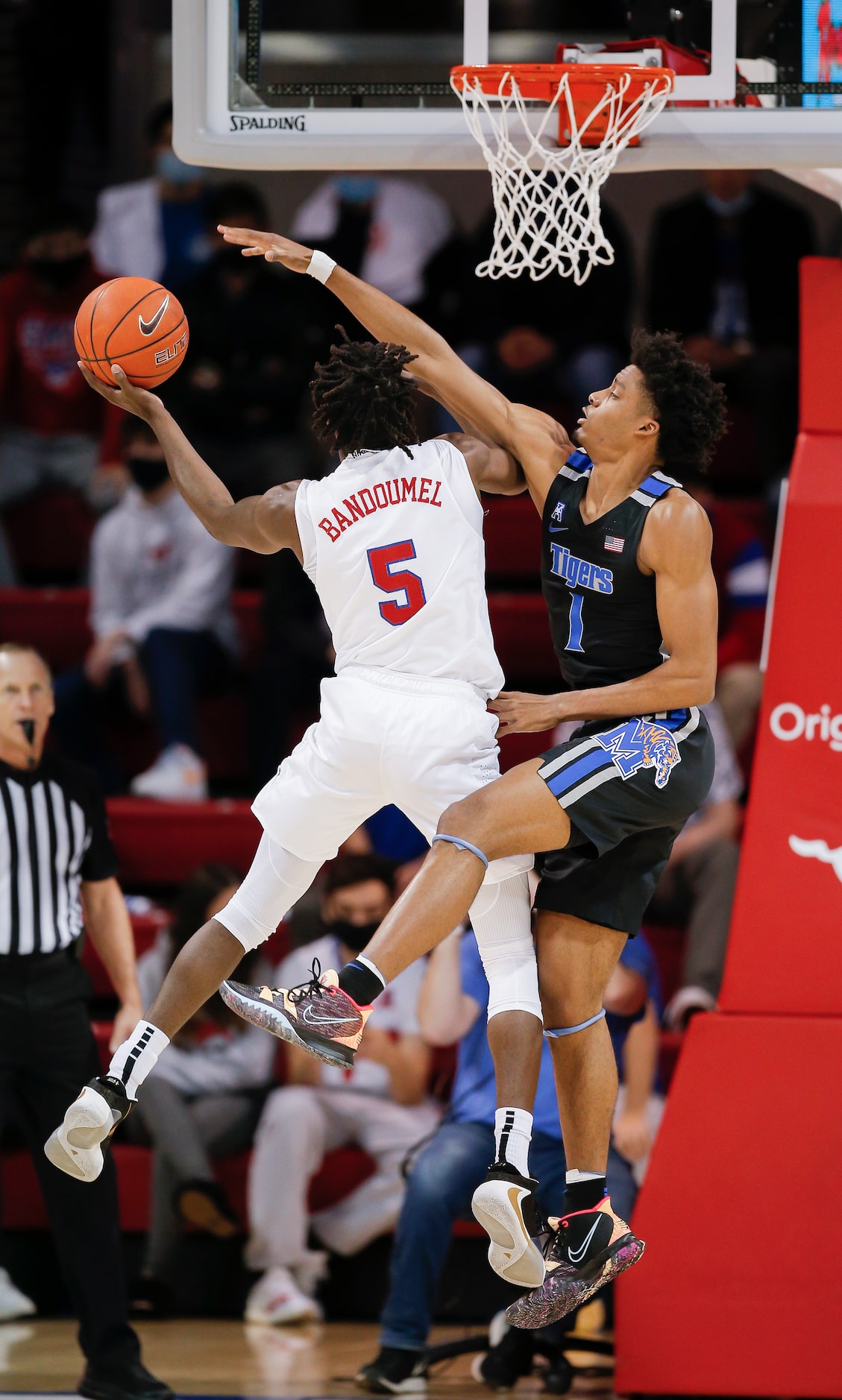 SMU guard Emmanuel Bandoumel (5) attempts a layup as Memphis guard Jayden Hardaway (1)...