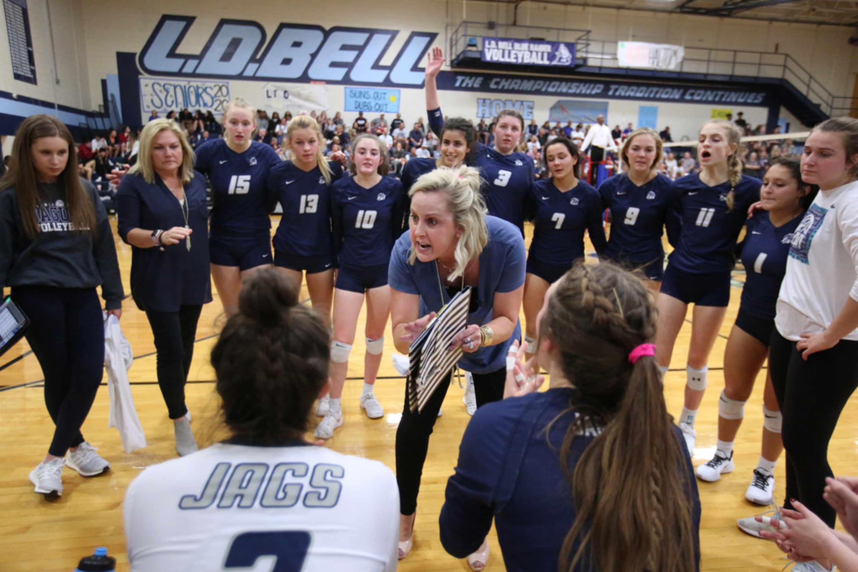 Jamie Siegel, Flower Mound volleyball head coach, talks to her players during a timeout...