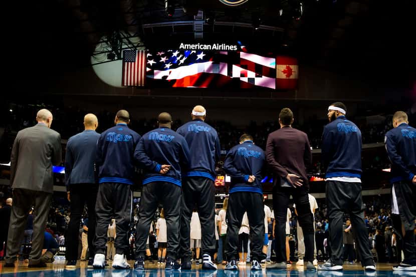 Dallas Mavericks line up for the national anthem before an NBA basketball game against the...