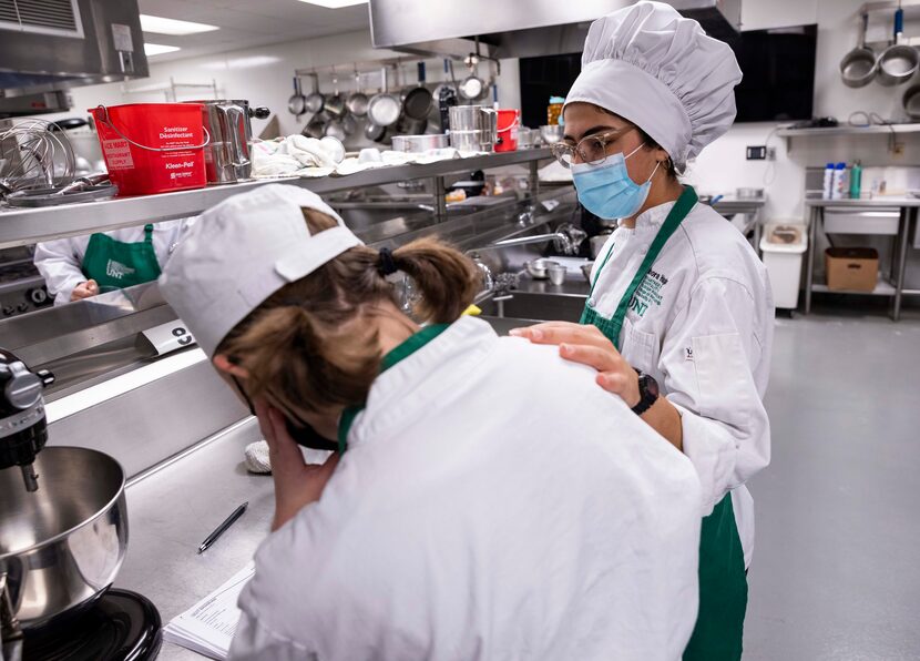 Junior Ann-Marie Jeremiassen (left) is consoled by sophomore Noora Haghar after something...