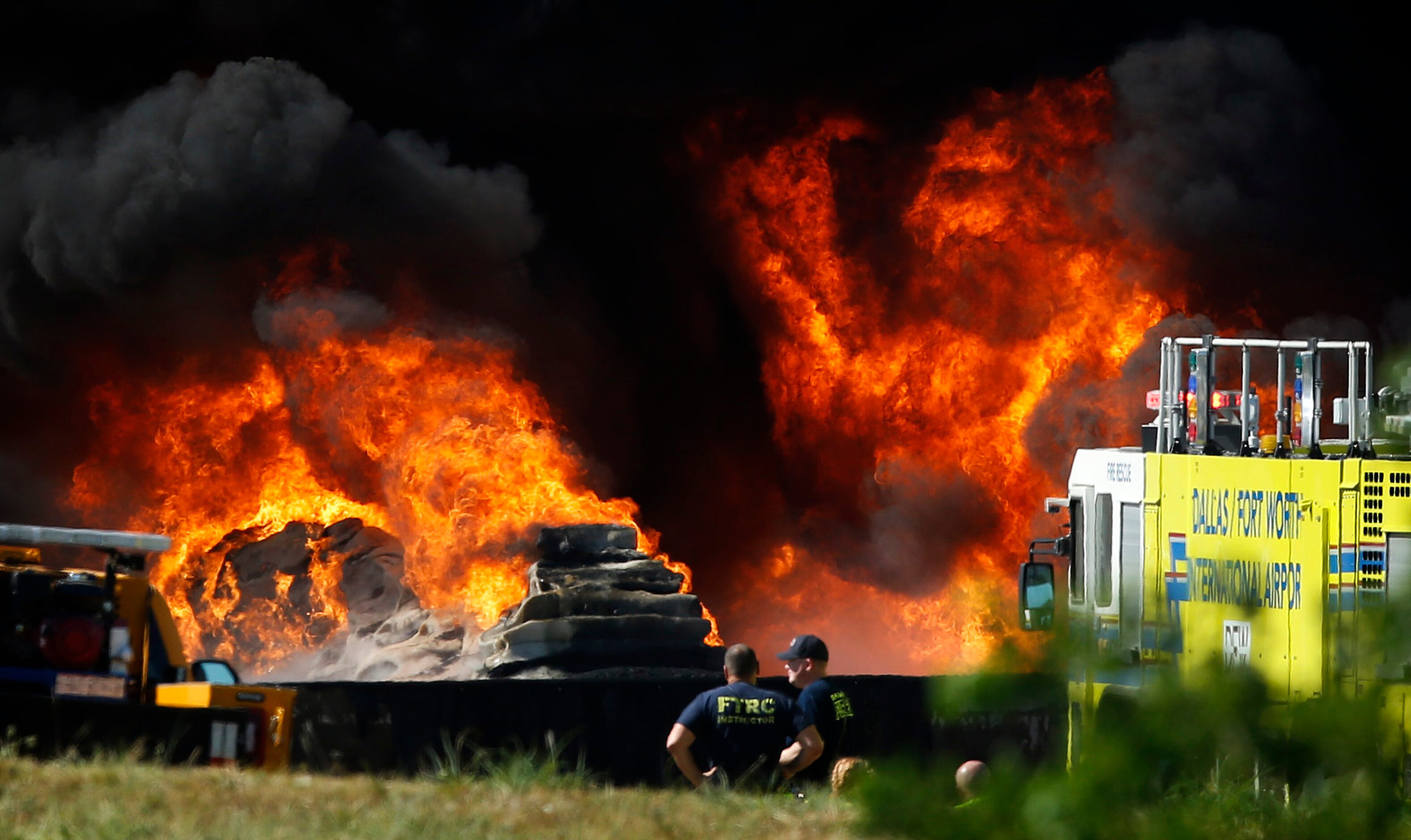 DFW International Airportfirefighters watch as burning plastic at Poly-America burn at 2000...