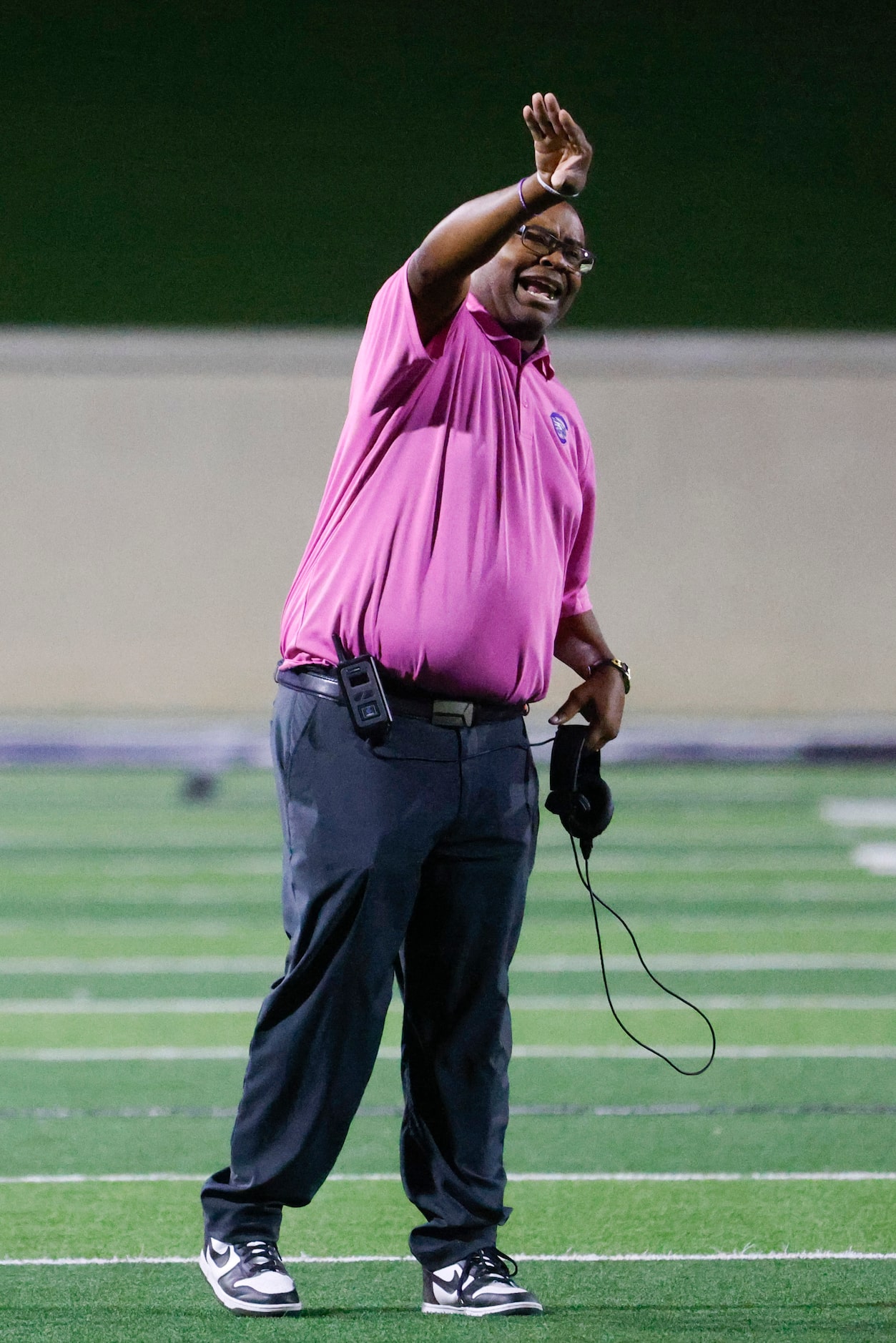 Crowley High head coach Carlos Lynn instructs the team against Trinity High during the first...