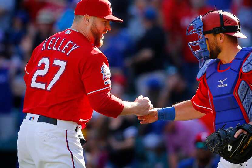 Texas Rangers relief pitcher Shawn Kelley is congratulated by catcher Jeff Mathis after...