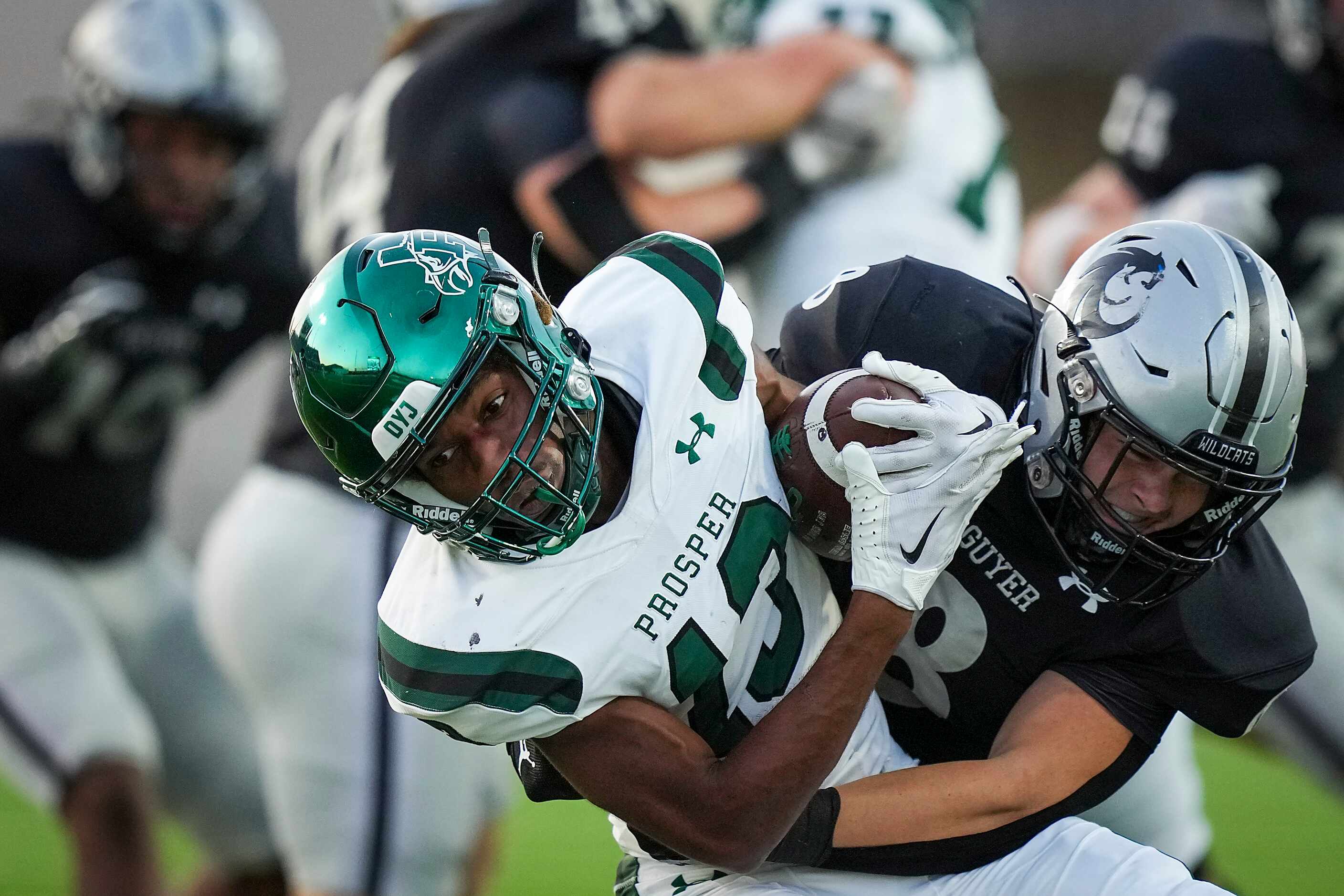 Prosper wide receiver Prentice Sanders (13) is brought down by Denton Guyer linebacker Blade...