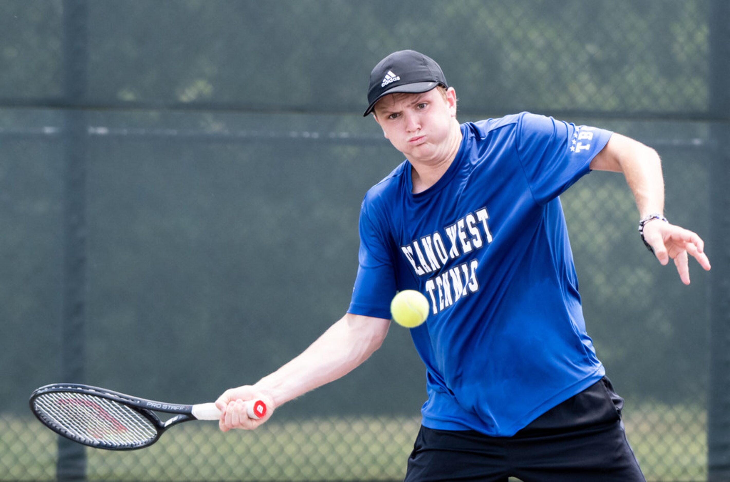 Plano West's Caden Moortgat returns the ball in a doubles match with teammate Emma Gener in...