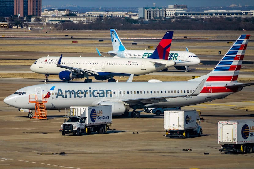 American Airlines, Delta Airline and Frontier Airlines aircraft are seen on the ramp and...