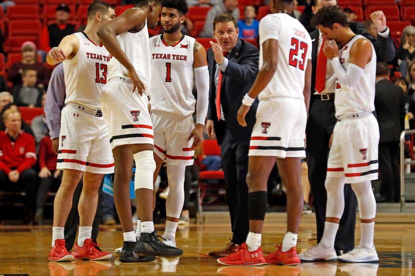 Texas Tech coach Chris Beard talks to his players in a timeout during the first half of an...