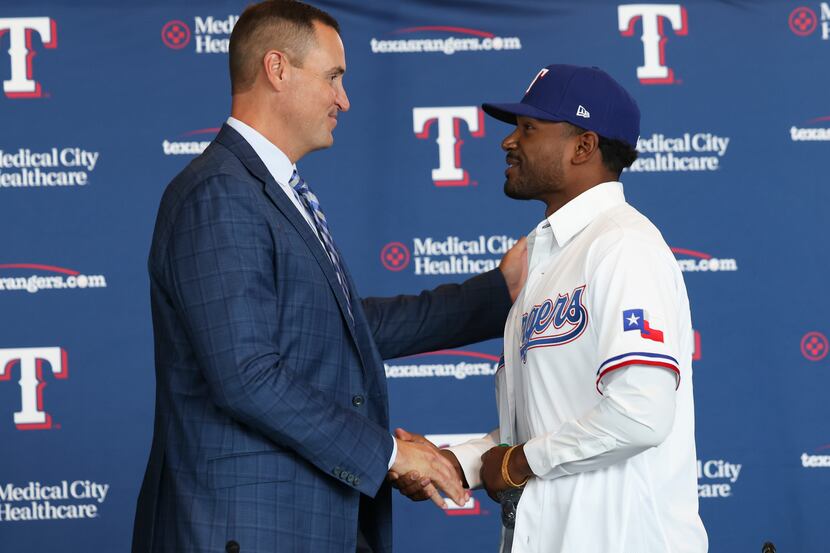 Chris Young, Texas Rangers General Manager shakes hands with Kumar Rocker, first-round draft...