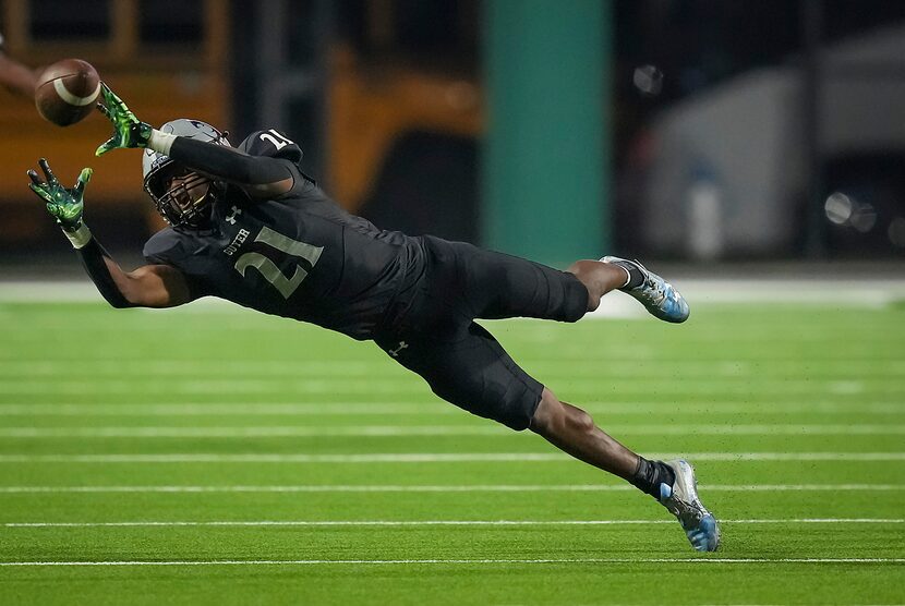 Denton Guyer defensive back Ryan Yaites (21) tries to intercept a pass during the first half...