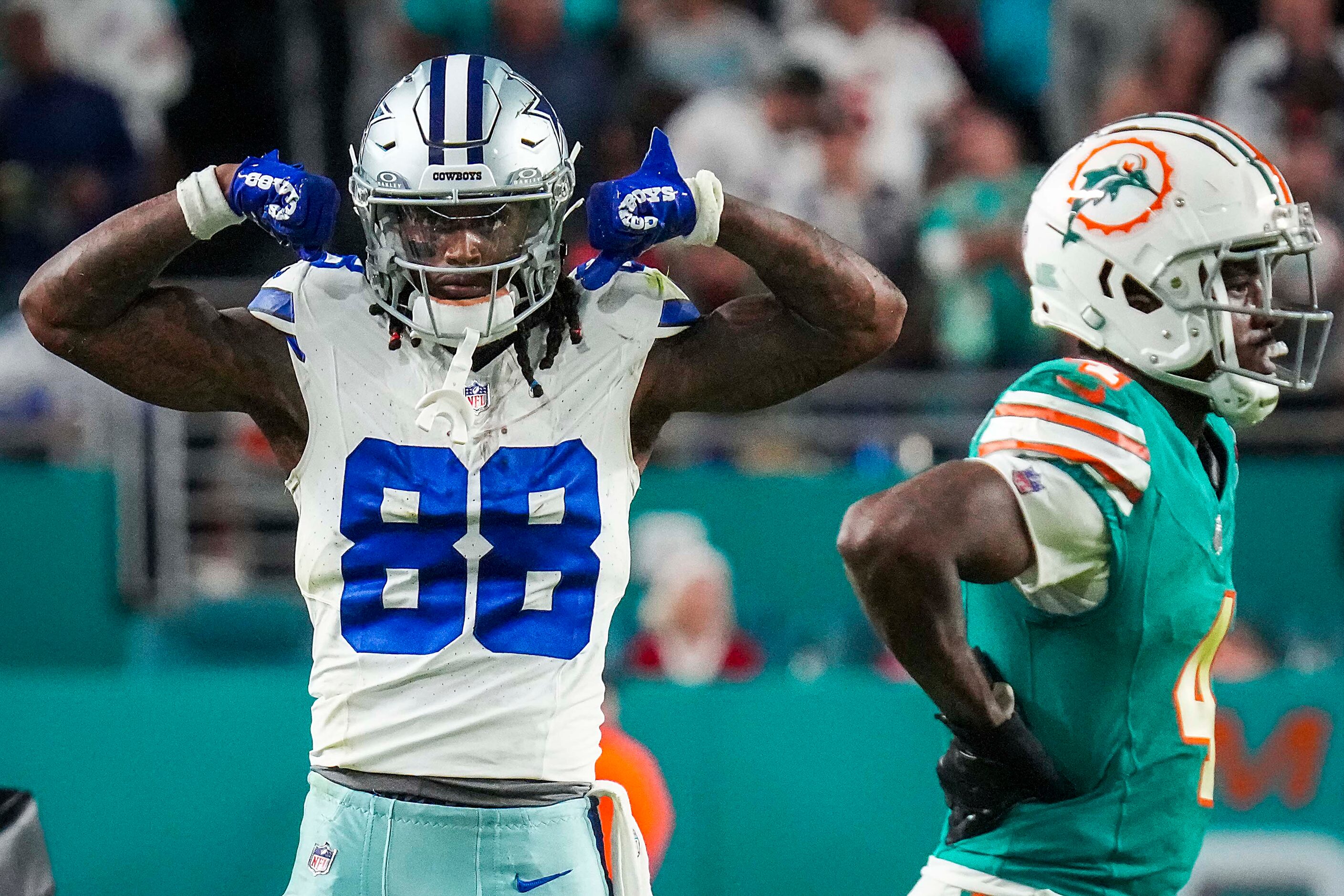 Dallas Cowboys wide receiver CeeDee Lamb (88) flexes after picking up a first down on a...