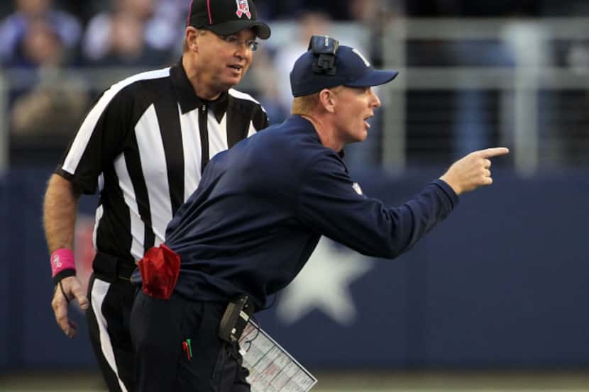 Dallas Cowboys head coach Jason Garrett questions a call in the first half of NFL football...