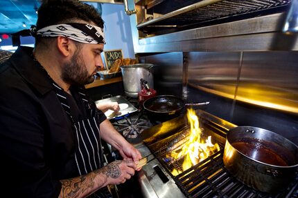 Regino Rojas chars branzino at his restaurant in Deep Ellum. People have visited Revolver...